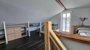 a bedroom with a bunk bed and a staircase at Attic floor with views over fields and sea in Sigtuna
