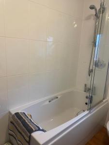 a bathroom with a bath tub with a shower at Linmore in Aviemore