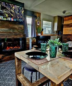 a kitchen with a wooden table and a fireplace at Martha's Inn Cresswell in Cresswell