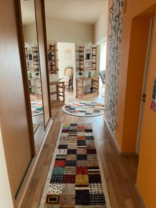 a hallway with a rug on the floor in a house at Király Családi Apartman- Royal Family Apartment in Budapest