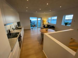 a kitchen and living room with a counter and a table at Sóljustova in Tórshavn