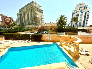 a large swimming pool in a city with tall buildings at Apartamento Dulce & Saladar Calpe in Calpe