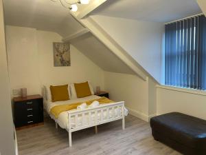 a bedroom with a white bed in a attic at Saltwell Rd - 4 Bdrm 5 beds Great for contractors in Gateshead