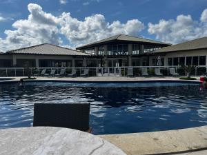 a swimming pool in front of a building at Apart Baixio Ponta de Inhambupe in Baixio