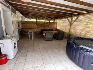 an outdoor patio with a table and a washer and dryer at Studio Roselande in Baillif