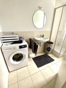 a bathroom with a washing machine and a sink at Entire apartment in Eggenfelden in Eggenfelden