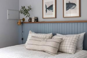 a bedroom with a bed with pillows on it at Bruny Boathouse in Alonnah
