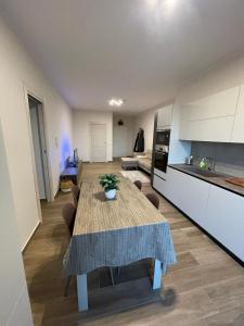 a kitchen and living room with a table in a room at Residence Guttuso in Gravina di Catania