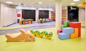 a library with colorful toys on the floor at Aminess Vival Maestral Hotel in Novigrad Istria