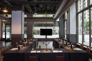 a row of tables in a room with a tv at Hotel Felix in Chicago