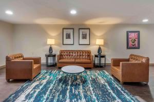 a lobby with couches and a table and a rug at Extended Stay America Suites - Arlington - Six Flags in Arlington
