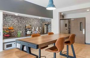 a dining room with a wooden table and chairs at Extended Stay America Premier Suites - Greenville - Spartanburg - I-85 in Duncan