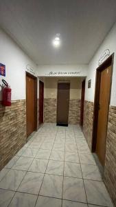 a hallway with two doors and a tile floor at Pousada vista pro vale do catimbau in Catimbau
