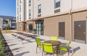 a patio with tables and chairs in front of a building at Extended Stay America Premier Suites - Greenville - Spartanburg - I-85 in Duncan