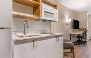a kitchen with a sink and a microwave at Extended Stay America Premier Suites - San Diego - San Marcos in San Marcos
