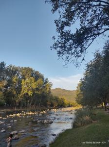 a person standing next to a river at Dpto Santa Rosa in Santa Rosa de Calamuchita