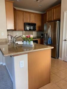 a kitchen with a counter with flowers on it at Spacious & Sunny South Reno Home, Near Trails & Shopping 3 beds in Steamboat
