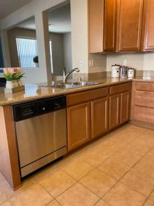 a kitchen with a sink and a dishwasher at Spacious & Sunny South Reno Home, Near Trails & Shopping 3 beds in Steamboat