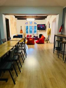 a large room with a table and chairs and a couch at Enjoy Hostel in Santiago