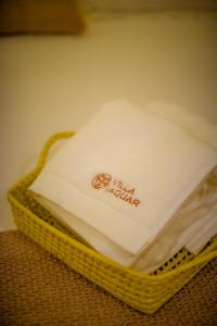 a basket filled with napkins sitting on a table at Villa Jaguar Fortim in Fortim