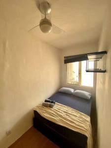 een kleine slaapkamer met een bed en een raam bij Casa no Santo Antônio in Salvador