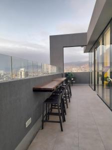 a bar on the roof of a building with tables and chairs at Hermoso departamentos Central Antofagasta in Antofagasta