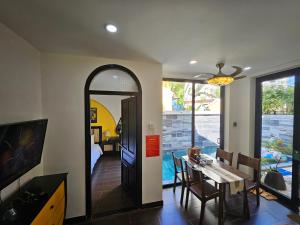 a dining room with a table and a mirror at Hoi An Rosie Villa - 2 Bedrooms with Private Pool and Local Hoi An Decor in Hoi An