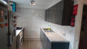 a kitchen with a sink and a refrigerator at 3- Room in central London in London