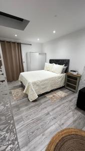 a bedroom with a bed and a wooden floor at London charming bedroom flat in London