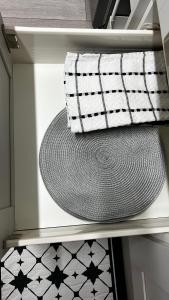 a hat and a towel on a shelf in a drawer at London charming bedroom flat in London