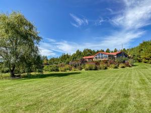 a large yard with a house in the background at Stunning Secluded Richibucto River Waterfront Cottage with Unparallel Privacy in Rexton