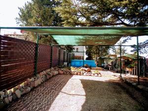 a person laying on the ground under a shade at dpto temporario in Las Compuertas