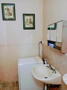 a bathroom with a sink and a toilet and a mirror at dpto temporario in Las Compuertas