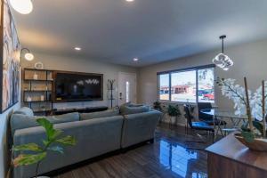 a living room with a couch and a flat screen tv at Discover the Ultimate Trending Hot Tub Retreat in El Paso
