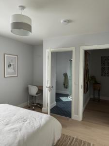 a bedroom with a bed and a desk and a chair at Double bedroom with private bathroom close to city center in Cork