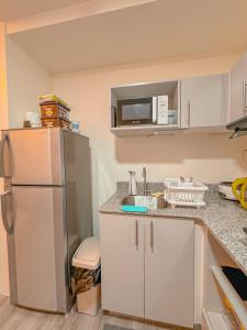 Η κουζίνα ή μικρή κουζίνα στο Amani Grand CityGate Unit 620