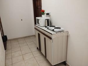a kitchen with a counter with a microwave on it at Qurban Apartment in Al ‘Awālī