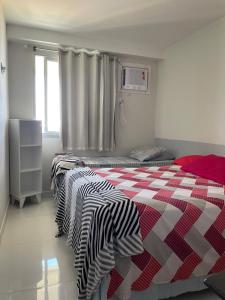 En eller flere senge i et værelse på Frente Mar Green Diamond Residencial + 94 billeder