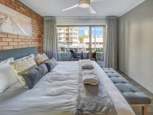 a large bed with two towels on it in a bedroom at “The Block” Mooloolaba - Unit 3 in Mooloolaba