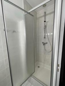 a shower in a bathroom with a glass door at Douce Demeure in Mortemart