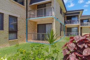 an apartment building with balconies and a yard at Unit 2 8 Banks Avenue in Tweed Heads
