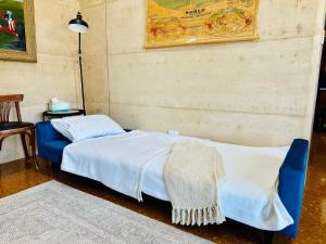 Un dormitorio con una cama con una manta. en Rammed Earth Retreat en Wagin