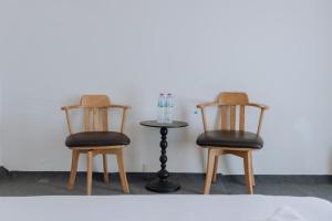 two chairs and a table in a room at Blue Carina Hotel - SHA Plus in Phuket Town