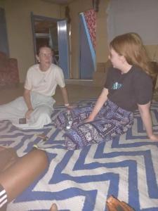 a man and a woman sitting on a bed at Lusis Homestay in Lautoka