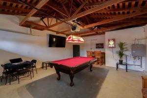 a pool table in a room with a ping pong ball at Historic Roseville Retreat with Hot Tub in Roseville