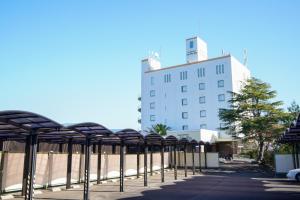 a row of chairs in front of a building at ホテル ラヴィアン HOTEL Lavien in Kobasaki