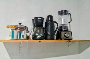 a shelf with a coffee maker and a blender at Casas de Campo Beija-Flor & Bem-Te-Vi, Mata Atlântica, Juquitiba, SP in Juquitiba