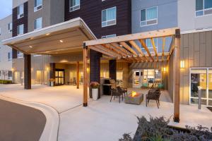 a pergola on a patio in front of a building at TownePlace Suites by Marriott Iron Mountain in Iron Mountain
