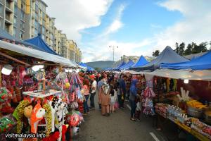 a crowd of people walking through a market with tents at Sinar Maju Homestay in Tanah Rata