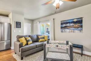 a living room with a couch and a kitchen at Vibrant Watermelon - Hot Tub, BBQ-Grill, King-Bed, Backyard, Parking in Colorado Springs